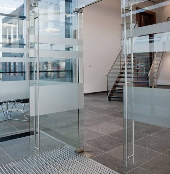 Glass door with a frosted band and steel handle