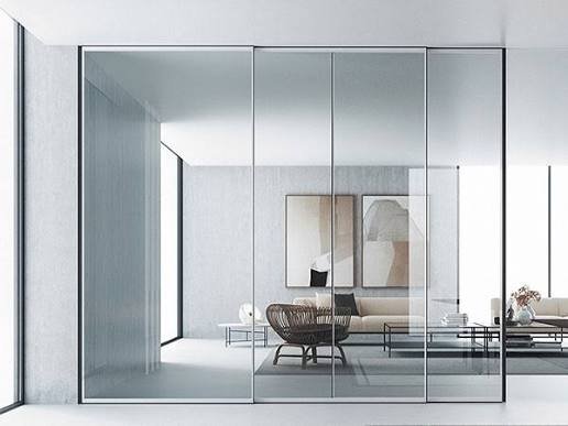Slim-frame glass partition between living spaces