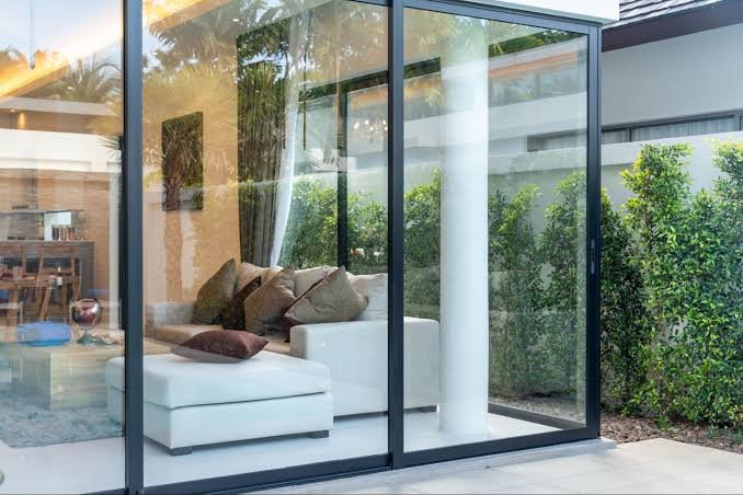 Large sliding glass doors opening to a garden